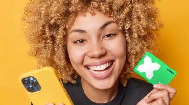 lady smiling and holding her Pluxee Card