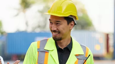 group of people on a construction site clapping their collgeaue