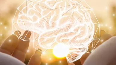 Holding an image of a brain made of lights