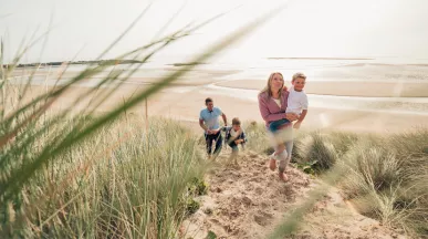 Family strolling along a beach
