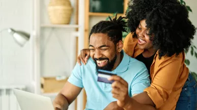man and woman online shopping with payment card