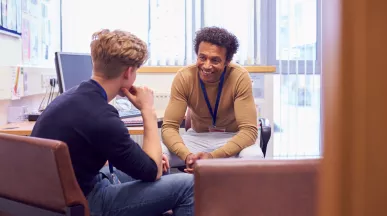 student and teacher having a conversation