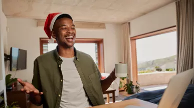 man sat at his desk with a Christmas hat on