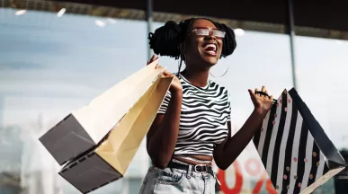 black lady very happy with her shopping bags