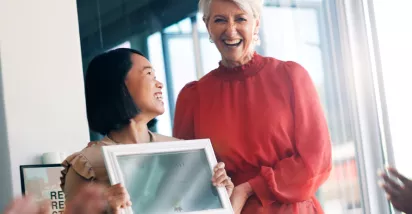 Woman giving a certificate to her colleague