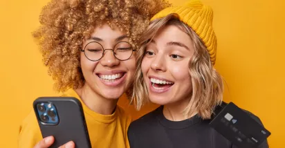 Happy and smiling women holding phone