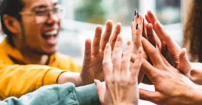 Group of people giving each other a high five