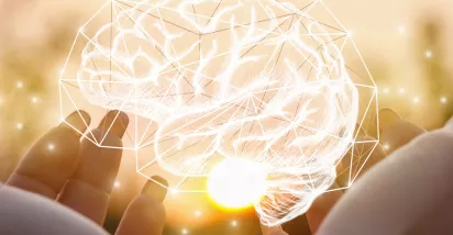 Holding an image of a brain made of lights