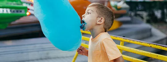 eVouchers - Young boy eating large blue Candyfloss