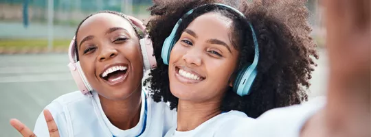 two young black women playing sports and listening to music