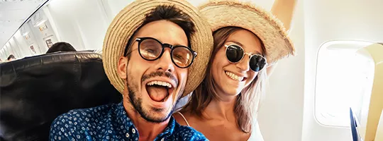 young white couple on a plane