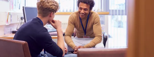 student and teacher having a conversation