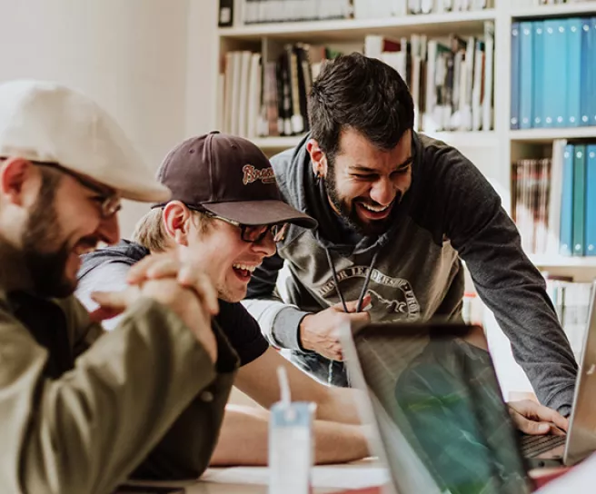 Making Saving Simple - Three men laughing and collaborating at work 