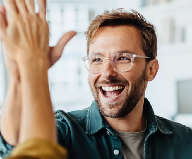 Happy employees giving each other a high five
